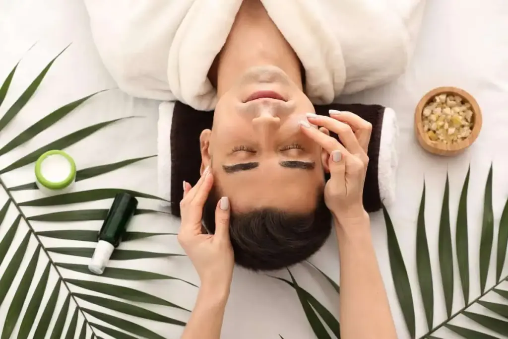 a man lying down with hands on face